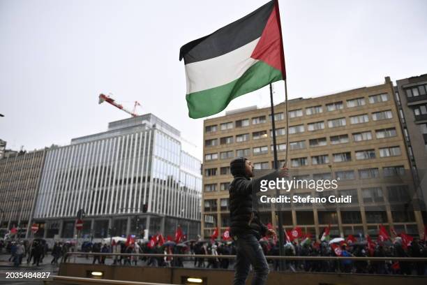 Man holds a Palestine flag during the Pro-Palestine Demonstration on February 24, 2024 in Milan, Italy. The war between Israel and Hamas, now in its...