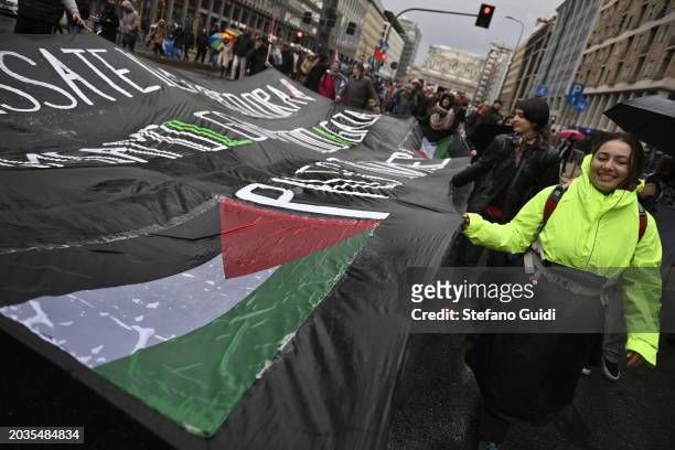 People hold a giant Palestine flag during the Pro-Palestine Demonstration on February 24, 2024 in Milan, Italy. The war between Israel and Hamas, now...