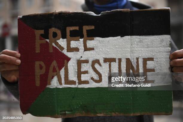 Hand of man holds a protest sign with written "Free Palestine" during the Pro-Palestine Demonstration on February 24, 2024 in Milan, Italy. The war...