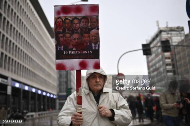 Man holds a protest sign with written "10 Participate in Gaza Genocide" during the Pro-Palestine Demonstration on February 24, 2024 in Milan, Italy....