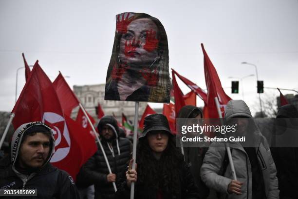 People hold a protest sign with an illustration of Italian Prime Minister Giorgia Meloni during the Pro-Palestine Demonstration on February 24, 2024...