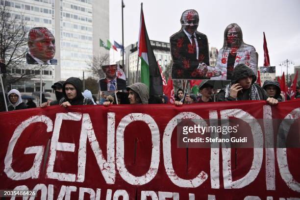 People hold a protest sign with illustrated Giorgia Meloni and Benjamin Netanyahu during the Pro-Palestine Demonstration on February 24, 2024 in...