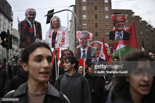 People hold a protest sign with illustrated Giorgia Meloni and Benjamin Netanyahu during the Pro-Palestine Demonstration on February 24, 2024 in...