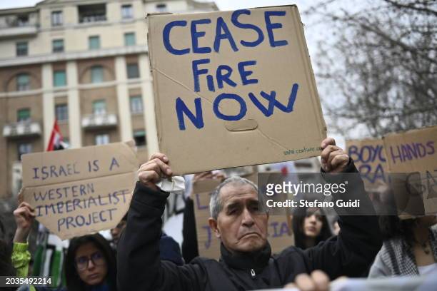 Man holds a protest sign with written "Cease fire now" during the Pro-Palestine Demonstration on February 24, 2024 in Milan, Italy. The war between...