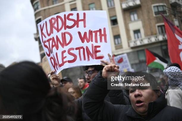 People hold a protest sign with written "Kurdish stand with Palestine" flag during the Pro-Palestine Demonstration on February 24, 2024 in Milan,...