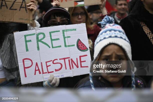 People hold a protest sign with written "Free Palestine" during the Pro-Palestine Demonstration on February 24, 2024 in Milan, Italy. The war between...