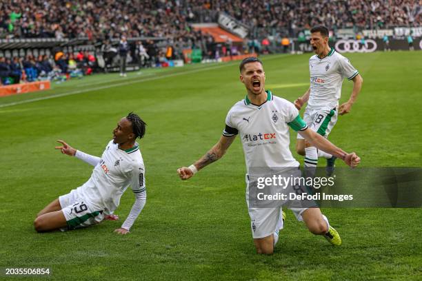 Julian Weigl of Borussia Moenchengladbach celebrates after scoring his team's second goal with teammates during the Bundesliga match between Borussia...