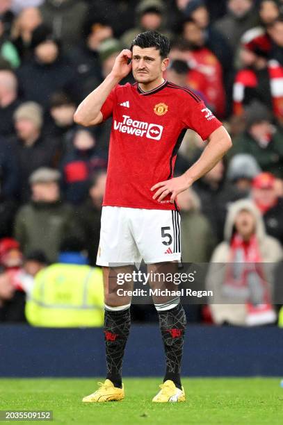 Harry Maguire of Manchester United looks dejected after Calvin Bassey of Fulham scores his team's first goal during the Premier League match between...