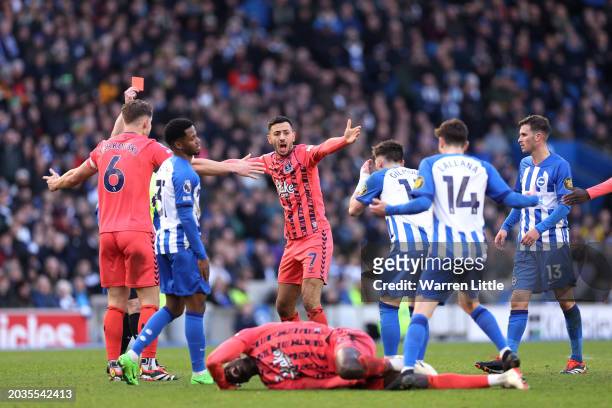 Dwight McNeil of Everton reacts after his teammate Amadou Onana is fouled by Billy Gilmour of Brighton & Hove Albion, a foul which results in a red...