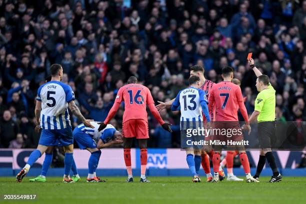 Billy Gilmour of Brighton & Hove Albion reacts as he is shown a red card by Referee Tony Harrington for a foul on Amadou Onana of Everton during the...