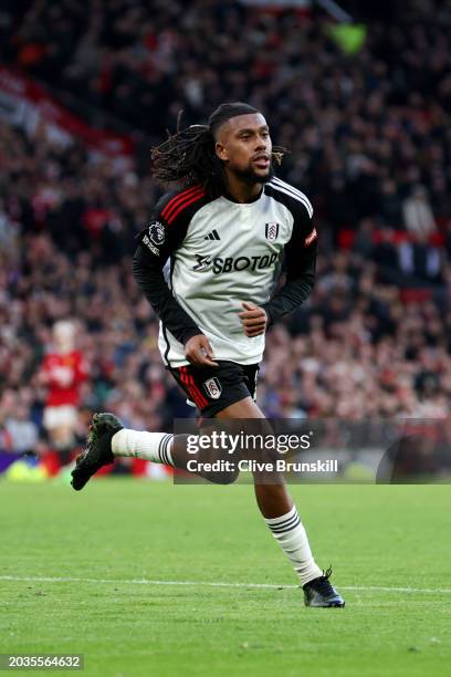 Alex Iwobi of Fulham celebrates scoring his team's second goal during the Premier League match between Manchester United and Fulham FC at Old...