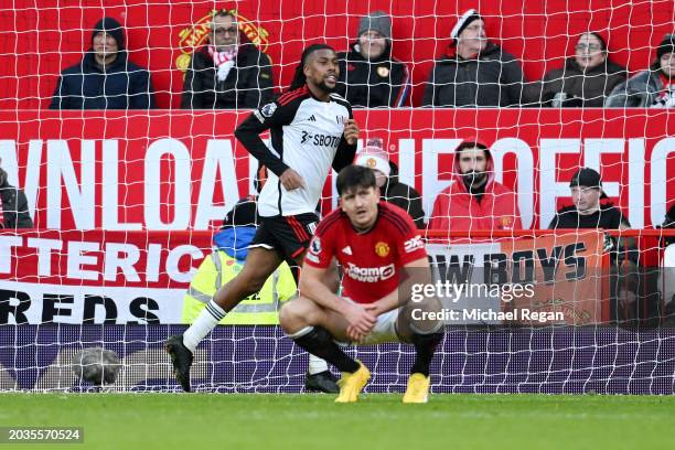 Alex Iwobi of Fulham celebrates scoring his team's second goal as Harry Maguire of Manchester United looks dejected during the Premier League match...