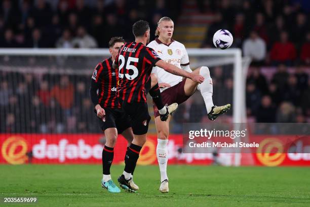 Erling Haaland of Manchester City is challenged by Marcos Senesi of AFC Bournemouth during the Premier League match between AFC Bournemouth and...