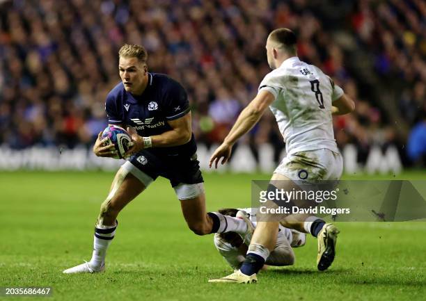 Duhan van der Merwe of Scotland runs with the ball whilst under pressure from George Furbank and Ben Earl of England during the Guinness Six Nations...