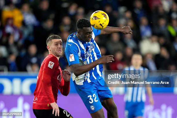 Samu Omorodion of Deportivo Alaves jumps for the ball whilst under pressure from Matija Nastasic of RCD Mallorca during the LaLiga EA Sports match...