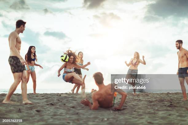 young friends playing soccer on the beach: summer vibes - beach football stock pictures, royalty-free photos & images