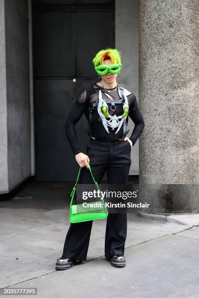 John Hui wears a Sapiensi skull top, Bagllet bag, Bence Borbely glasses, FBMT trousers, Koi boots, JJ Malibu harness, Spice Posh Studios mesh top and...