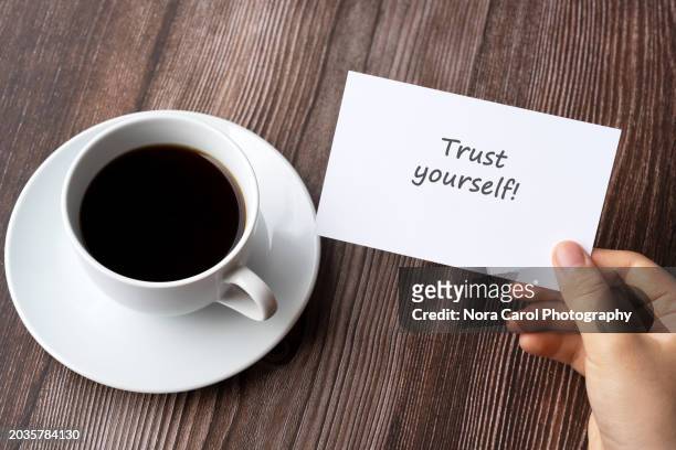 hand holding paper note with text trust yourself - words of wisdom stock pictures, royalty-free photos & images
