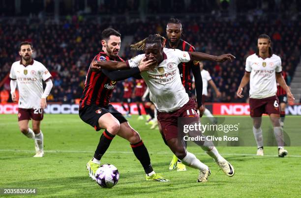 Jeremy Doku of Manchester City is challenged by Adam Smith of AFC Bournemouth during the Premier League match between AFC Bournemouth and Manchester...