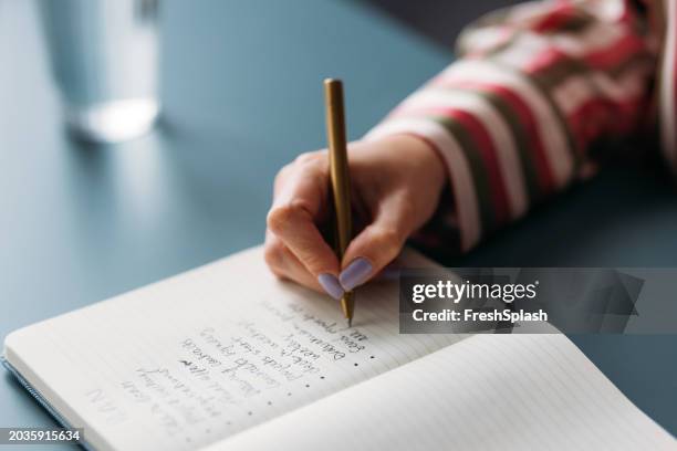 focused woman writing in notebook, creative planning and ideas - to do list stock pictures, royalty-free photos & images