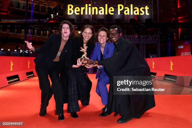 Judith Lou Lévy, Mati Diop, Eve Robin and Fabacary Assymby Coly pose with the Golden Bear for Best Film for “Dahomey” on the red carpet after the...