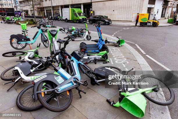 Rental bikes are pictured scattered across a pavement on 26th February 2024 in London, United Kingdom. E-bikes left unsafely on pavements present...