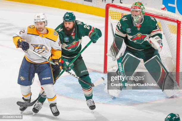 Zach Bogosian and Filip Gustavsson of the Minnesota Wild defend their goal against Tommy Novak of the Nashville Predators during the game at the Xcel...