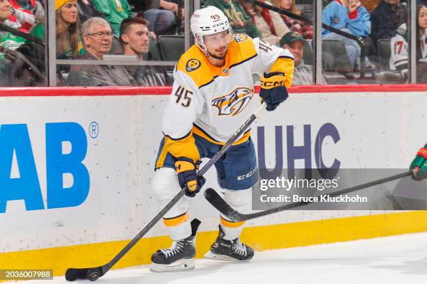 Alexandre Carrier of the Nashville Predators handles the puck against the Minnesota Wild during the game at the Xcel Energy Center on January 25,...