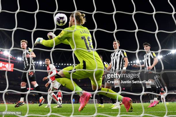 Gabriel of Arsenal heads a shot which is later deflected by Sven Botman of Newcastle United past teammate Loris Karius, resulting in an own-goal and...