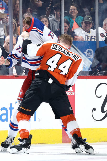 Matt Rempe of the New York Rangers and Nicolas Deslauriers of the Philadelphia Flyers fight during the first period at the Wells Fargo Center on...