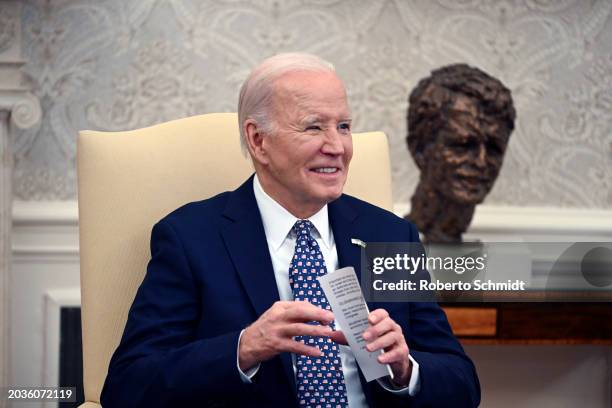 President Joe Biden smiles as he meets with Senate Minority Leader Mitch McConnell , House Speaker Mike Johnson , Senate Majority Leader Chuck...