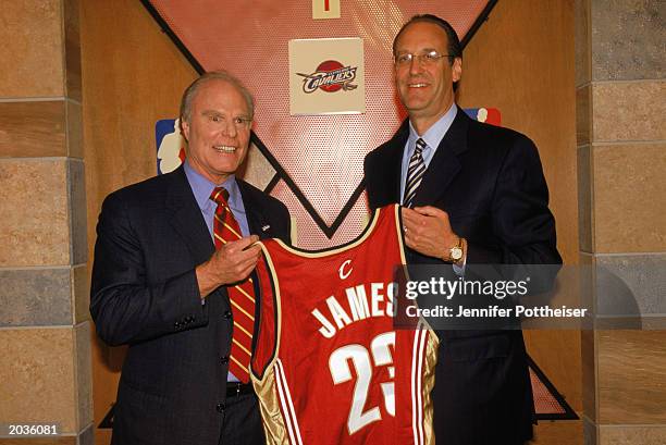 Cavaliers owner Gordon Gund and deputy commissioner Russ Granik pose for a portrait as they hold up the jersey to be worn by first draft pick LeBron...