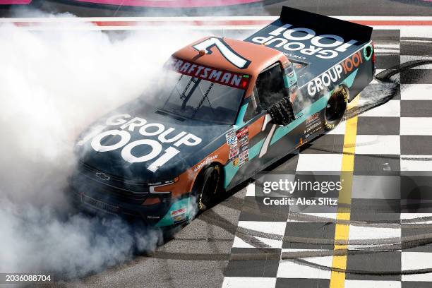 Kyle Busch, driver of the Group 1001 Chevrolet, celebrates with a burnout after winning the NASCAR Craftsman Truck Series Fr8 208 at Atlanta Motor...