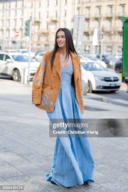 Paola Turani wears blue dress, brown blazer outside Ermanno Scervino during the Milan Fashion Week - Womenswear Fall/Winter 2024-2025 on February 24,...