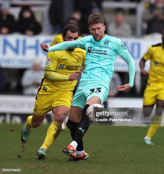 Patrick Brough of Northampton Town plays the ball away from Mason Bennett of Burton Albio during the Sky Bet League One match between Burton Albion...