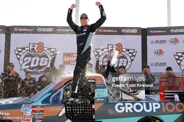 Kyle Busch, driver of the Group 1001 Chevrolet, celebrates in victory lane after winning the NASCAR Craftsman Truck Series Fr8 208 at Atlanta Motor...