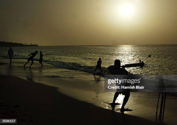 Locals play cricket on May 28, 2003 on the beach in St. George's, Grenada.