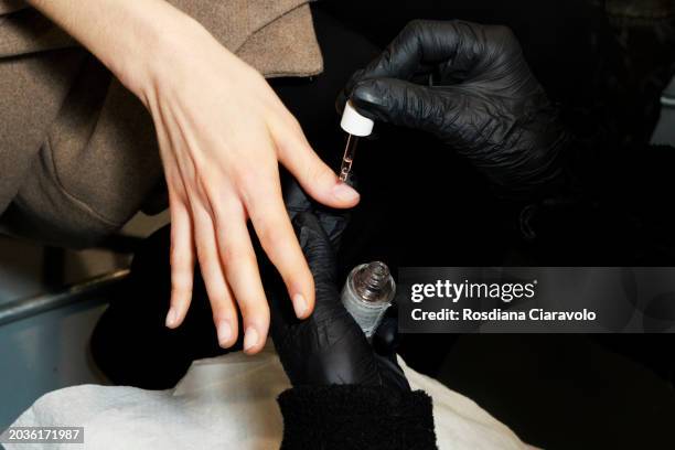 Model gets nails done backstage ahead of the Ermanno Scervino fashion show during the Milan Fashion Week Womenswear Fall/Winter 2024-2025 on February...