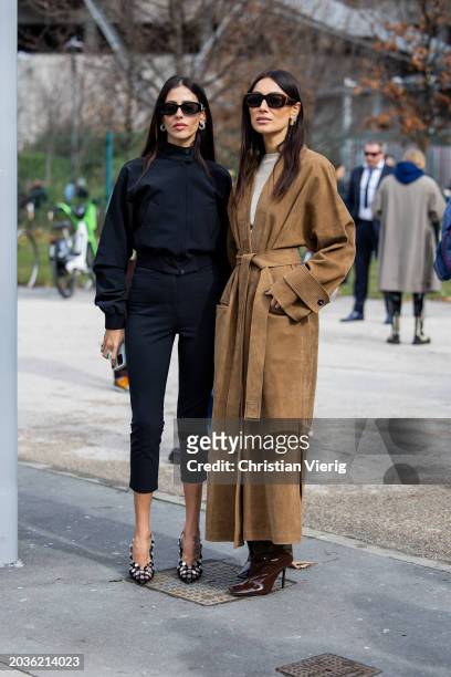 Gilda Ambrosio wears black cropped pants, jacket, heels & Giorgia Tordini wears brown wild leather coat, boots outside Ferragamo during the Milan...