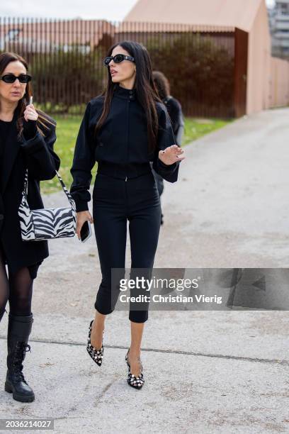 Gilda Ambrosio wears black cropped pants, jacket, heels outside Ferragamo during the Milan Fashion Week - Womenswear Fall/Winter 2024-2025 on...