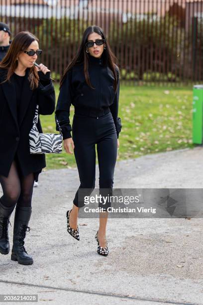 Gilda Ambrosio wears black cropped pants, jacket, heels outside Ferragamo during the Milan Fashion Week - Womenswear Fall/Winter 2024-2025 on...