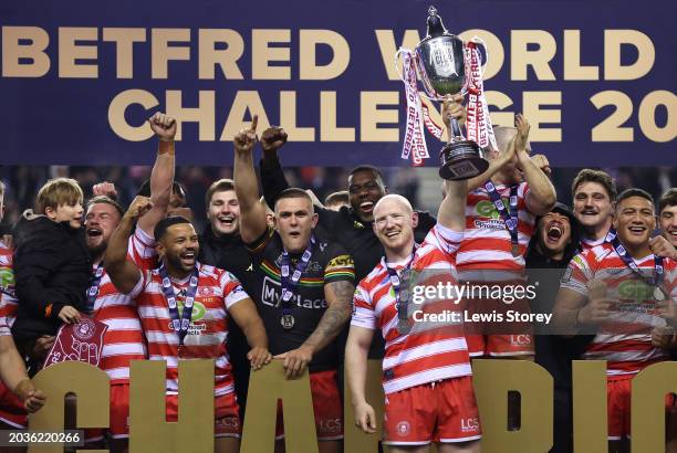 Liam Farrell of Wigan Warriors lifts the Betfred World Club Challenge trophy after the team's victory in the Betfred World Club Challenge match...