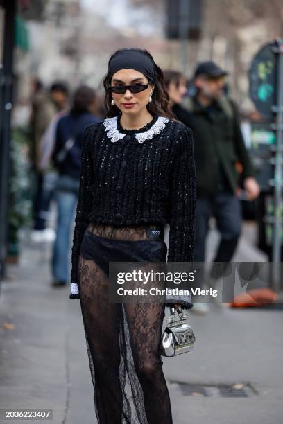 Fer Millian Delaroiere wears head band, slip, laced transparent skirt, heels, cropped knit cardigan outside Dolce & Gabbana during the Milan Fashion...