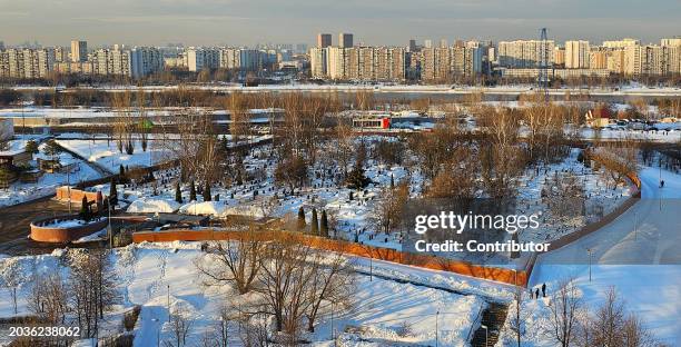 Russian Police officers guard the area near the fence of the Borisov cemetery where Alexey Navalny is expected to be buried this week, on February...