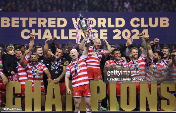 Liam Farrell of Wigan Warriors lifts the Betfred World Club Challenge trophy after the team's victory in the Betfred World Club Challenge match...