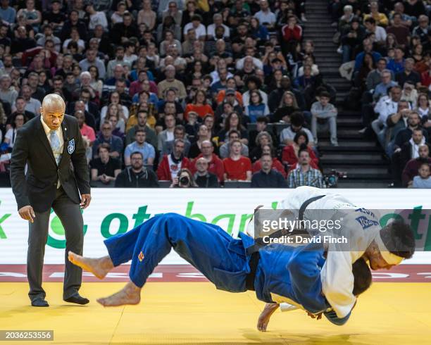 Watched by referee Olivier Desroses of France, Erlan Sherov of Kyrgyzstan throws Rafael Macedo of Brazil squarely on his back for an ippon with...