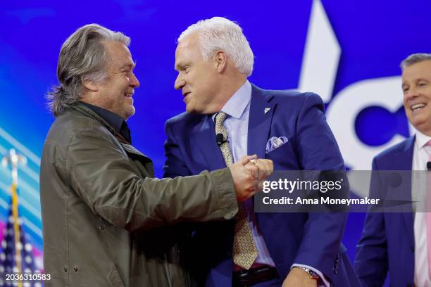 Chairman of American Conservative Union Matt Schlap gives Steve Bannon , former advisor to former President Donald Trump, a high five as he walks...