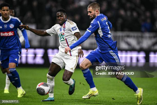 Lyon's Ghanaian forward Ernest Nuamah fights for the ball with Strasbourg's French defender Thomas Delaine during the French Cup quarter final match...