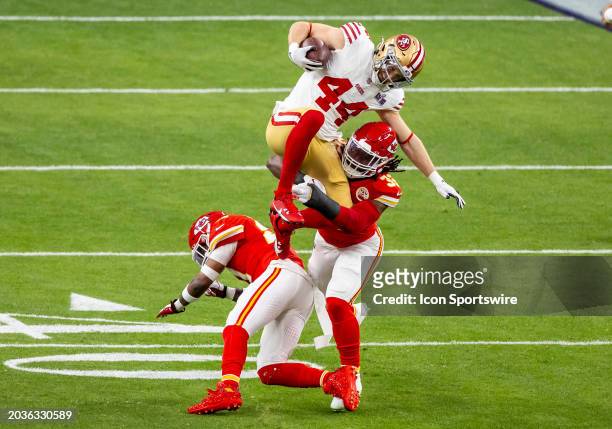 San Francisco 49ers fullback Kyle Juszczyk attempts to leap over Kansas City Chiefs linebacker Nick Bolton during Super Bowl LVIII between the Kansas...