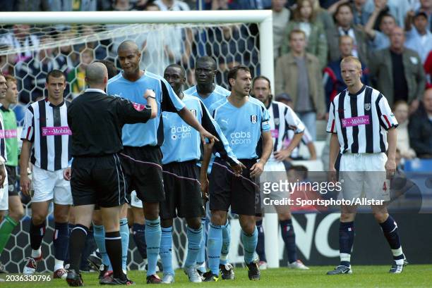 Referee Mike Dean and Fulham Players in incident before sending off Papa Bouba Diop of Fulham during the Premier League match between West Bromwich...